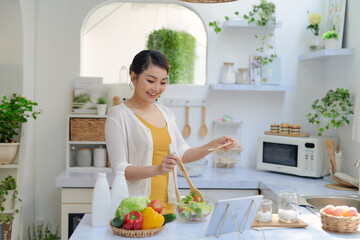 Young woman cooking in the kitchen