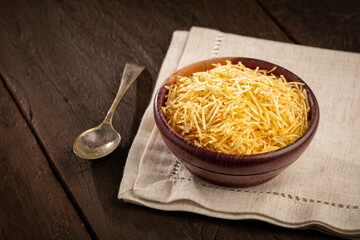 Straw potatoes in a bowl on the table.