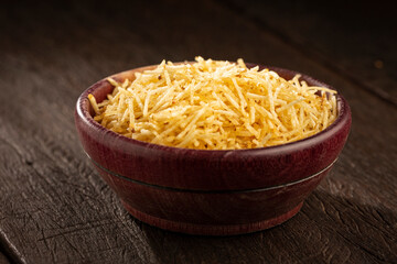 Straw potatoes in a bowl on the table.
