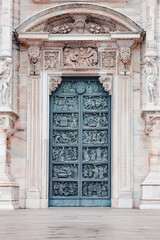 Artwork on the door of Duomo di Milano or Milan Cathedral in Milan, Italy