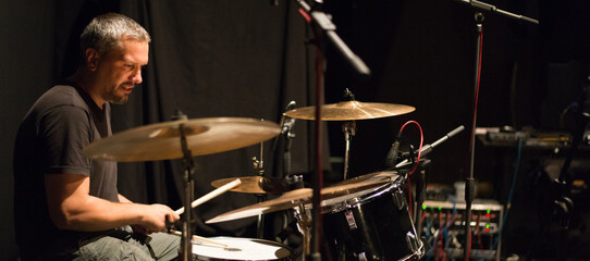 Drummer playing drums in recording studio