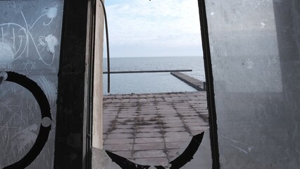 View on marina Azov Sea Mariupol Ukraine from building with broken windows.