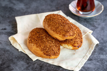 Cheese Pogaca. Turkish pastry product. Sesame pogaca on a dark background. Close-up. local name kasarli pogaca