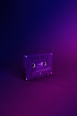Audio cassette close up, isolated on purple and blue background. Analog Audio Tape. Audio K7 Tape...