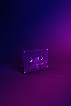 Audio cassette close up, isolated on purple and blue background. Analog Audio Tape. Audio K7 Tape isolated and center on purple degradee background.