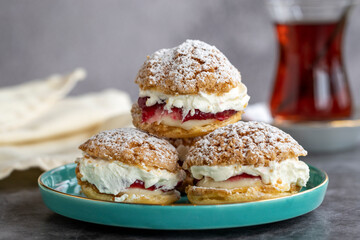 Cake with raspberry sauce and cream. pastry product. Snack cake on dark background. Close-up