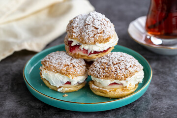 Cake with raspberry sauce and cream. pastry product. Snack cake on dark background. Close-up