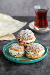 Cake with raspberry sauce and cream. pastry product. Snack cake on dark background. Close-up