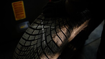 Repair service for wheel tire of car. Man show outside place of damage marked with chalk