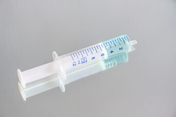Close-up Medizinische Spritze. Darin hellblaue Flüssigkeit, Medikament, Impfstoff, Serum....