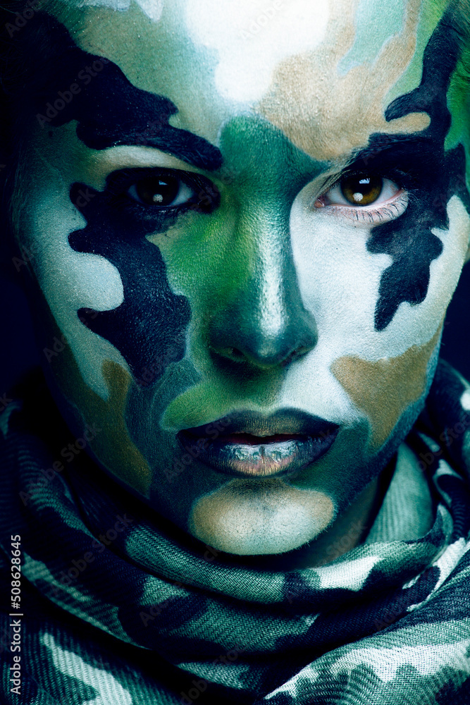 Wall mural Beautiful young fashion woman with military style clothing and face paint make-up, khaki colors, halloween celebration