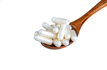 Fototapeta na wymiar Medical capsules in a wooden spoon on a white background.