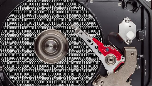 Hard Disk Drive head reads information from disk. Working HDD platter with binary code. Seamless loop