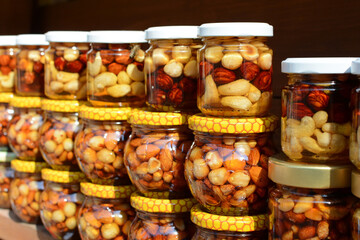 Many jars of honey with nuts