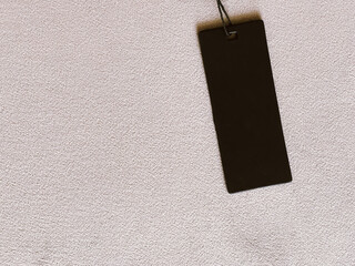 Luxury black fashion label tag, sale price card on fabric background, shopping and retail