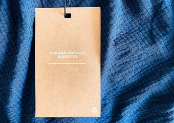 Contains recycled polyester fashion label tag, sale price card on luxury fabric background,...