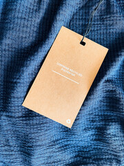 Contains recycled polyester fashion label tag, sale price card on luxury fabric background,...