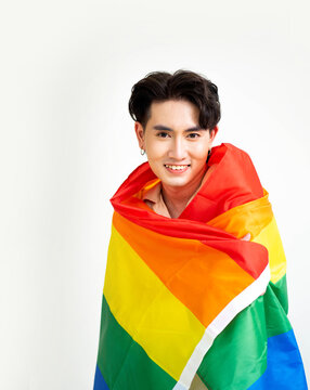 Smiling transgender man with pride flag. People lifestyle fashion lgbtq concept.