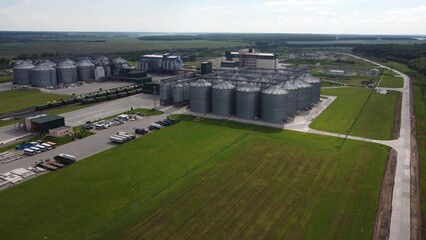 long rows of huge white gas tanks connected with pipeline system at refinery plant on sunny day aerial view