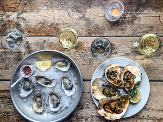 Gourmet luxury lunch. eating oysters. Lunch for two plate with half dozen of fresh oysters lemon...