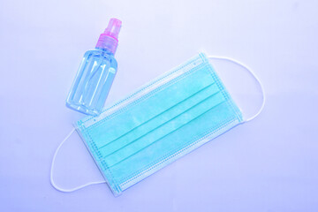 Alcohol bottles with Green disposable hygienic mask. The concept of protect, resistance, fight.