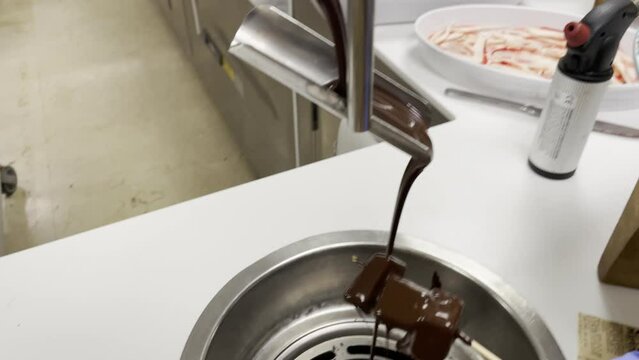 Fl&uuml;ssige hei&szlig;e Schokolade l&auml;ft herunter und man kann damit fr&uuml;chte &uuml;berziehen.