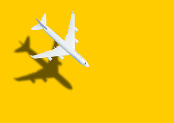 Miniature toy airplane on yellow background. Trip by airplane. © Angelov