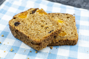 Two pieces of whole-grain sprouted grain bread with dried fruits (dried apricots, prunes) on a napkin close-up. Healthy lifestyle. Proper nutrition.