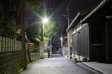 夜の神社の玉垣と住宅街
