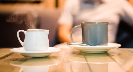 cup of coffee with milk, hot drink at a restaurant or cafeteria table