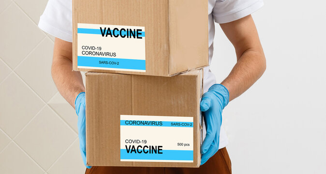 Lab Assistant Carrying Box With Vaccines For Covid 19