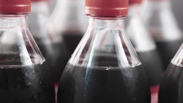 plastic bottles of soft drink on table 