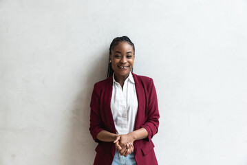 Beautiful young successful female African American business woman CEO in a casual suit, standing cute and confidently with arms folded and smiling. Promoted on job woman teenage girl is happy - obrazy, fototapety, plakaty