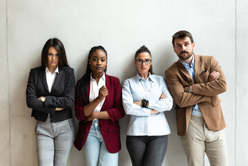 Portrait of experts businesspeople standing with arms crossed in office. Group of successful business freelancers colleagues with confident facial expression in the office building.