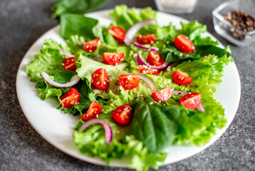 Green vegan salad from vegetables and green ,leaves mix on stone background.Healthy food.