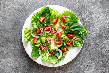 Green vegan salad from vegetables and green ,leaves mix on stone background.Healthy food.