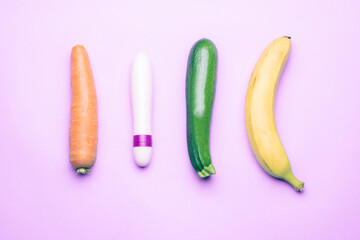 female dildo with phallic shaped vegetables on a light purple background photographed from above and horizontally