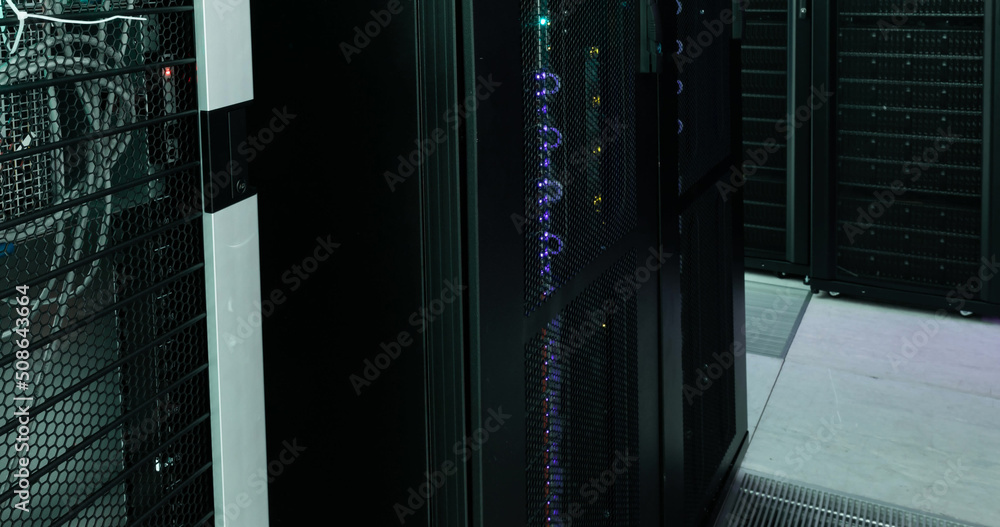 Poster image of empty corridor with rows of computer servers with green and purple lights