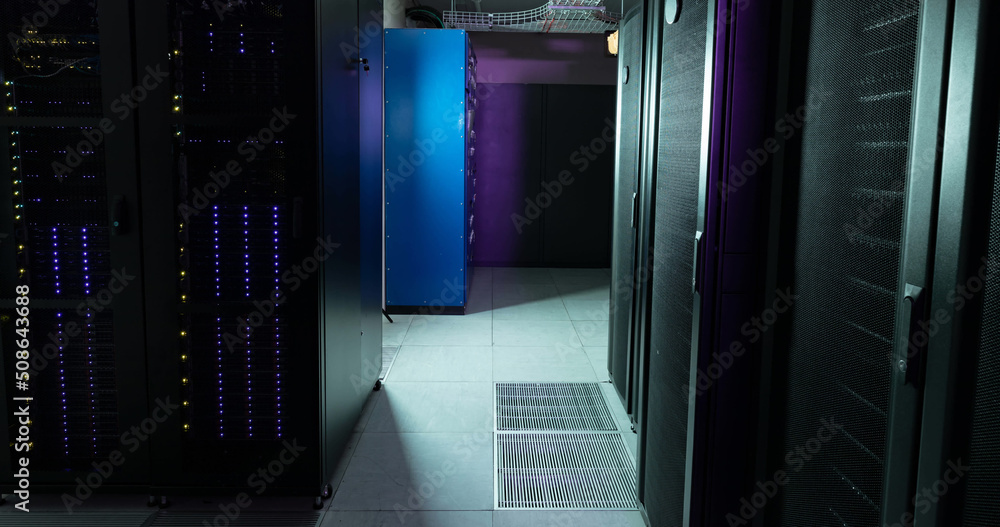 Poster image of empty corridor with rows of purple and blue computer servers