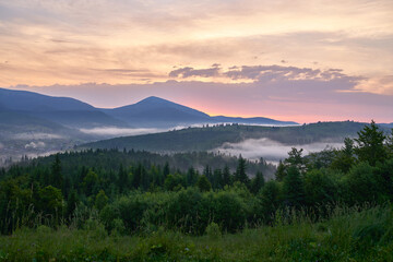Fototapeta premium Amazing summer sunset over mountains with beautiful green nature. Concept of adventure, travelling and environment.