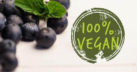 Image of 100 percent vegan text in green over fresh organic blueberries - obrazy, fototapety, plakaty