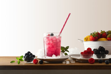Drink with berries and ice on wooden table isolated background