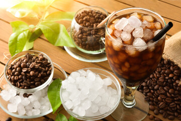 Iced coffee on wooden table in nature elevated view