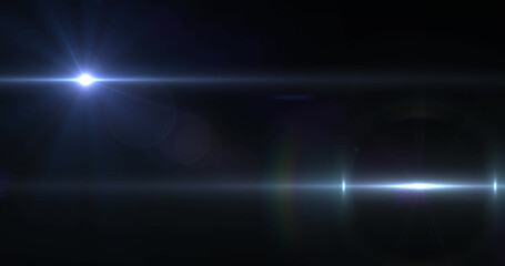 Image of two beams of white light moving across black background