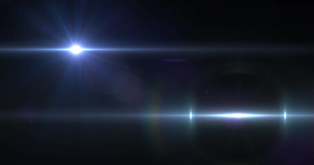 Image of two beams of white light moving across dark background