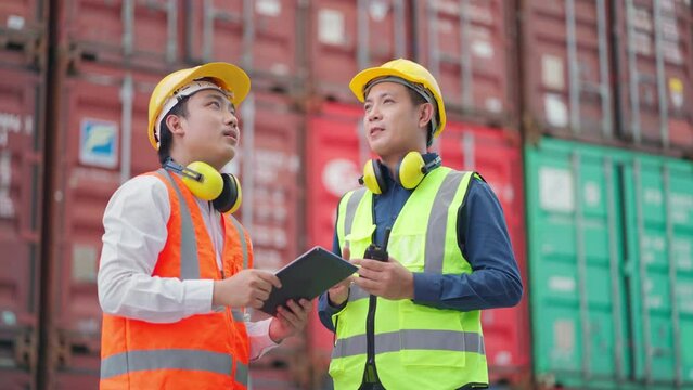 Dock manager and engineer worker discuss on project with smile in shipping container yard. Import and export product. Manufacturing transportation and global business concept. Successful on project 