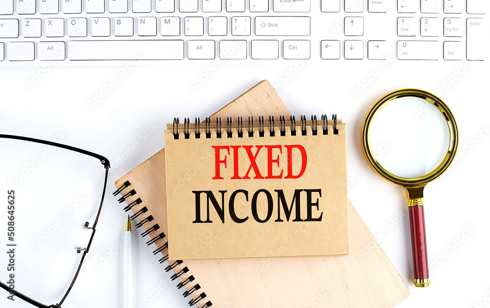 Poster fixed income text in the office notebook with keyboard, magnifier and glasses , business concept