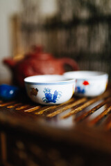 red handmade teapot with the image of a dragon stands