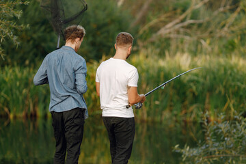 Two men fishing near the river