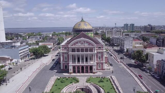 Amazonas theatre building and Manaus city center skyline with Rio Negro background in beautiful aerial drone view. Amazon, South America, Brazil. 4K. Concept of cityscape, travel, architecture. 4K

